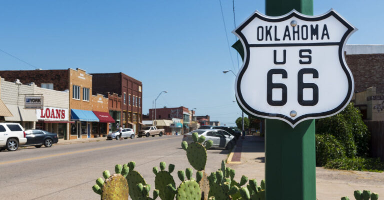 street in a small town in Oklahoma with Route 66 sign