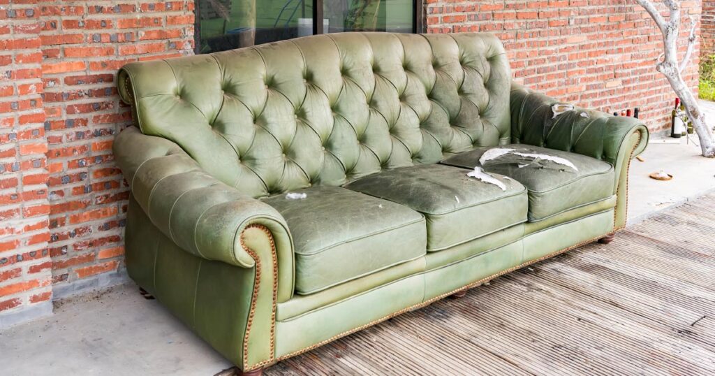 Get rid of household items. Image of damaged couch outside.