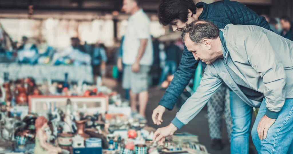 Man at swap meet. Brining household items to sell at a swap meet.