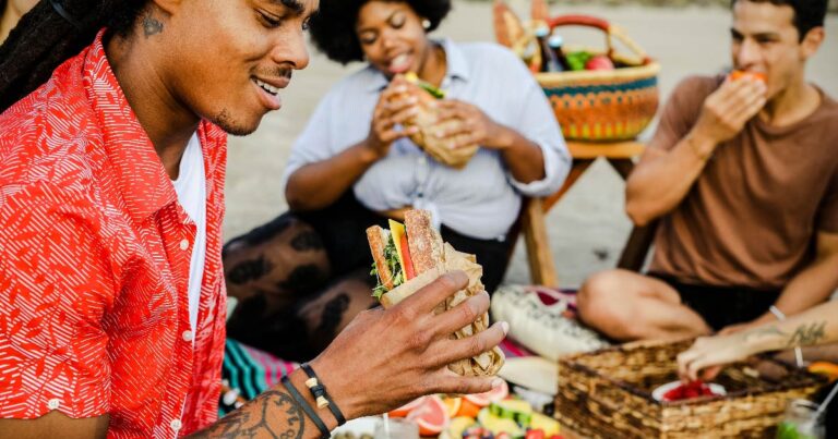 Delis Featured image. Group of people eating sandwiches