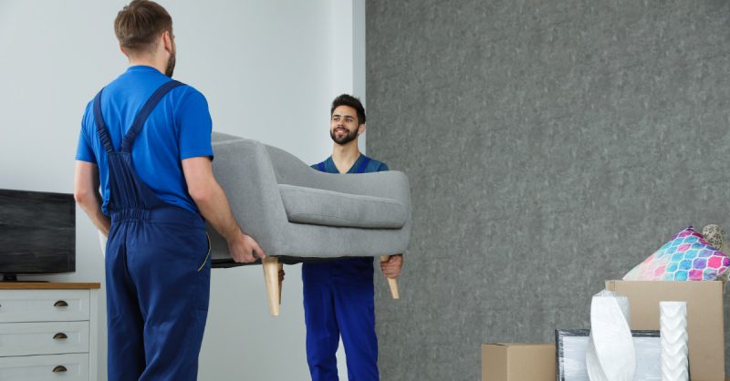 2 men moving a couch - working for moving companies