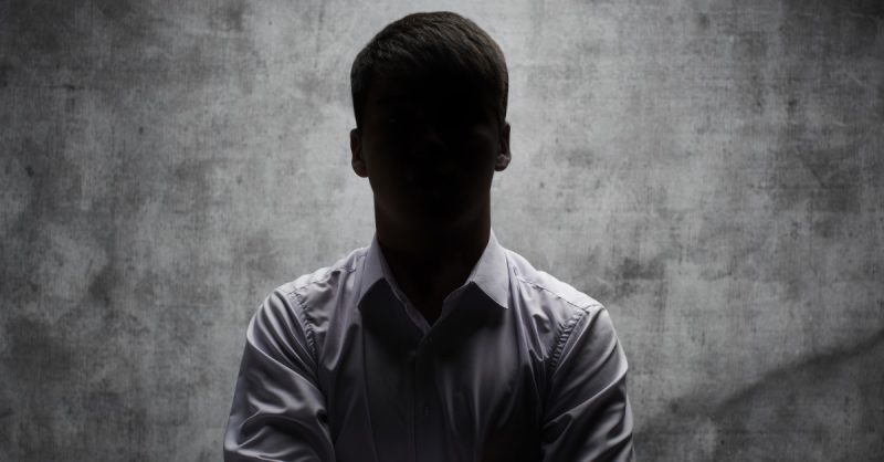 Notorious Criminals image of individual cloaked in shadow