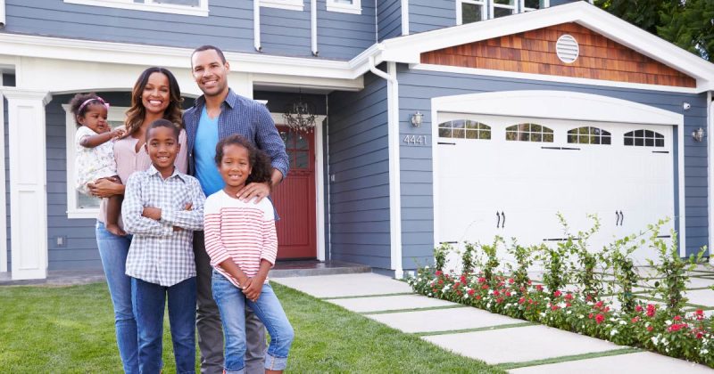 Fall Cleaning Checklist image of family in front yard with beautiful home in the background