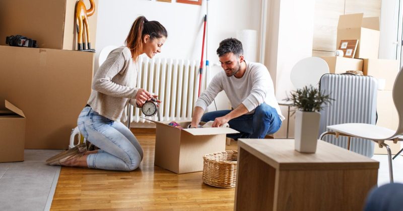 Couple boxing items to donate or throw away.